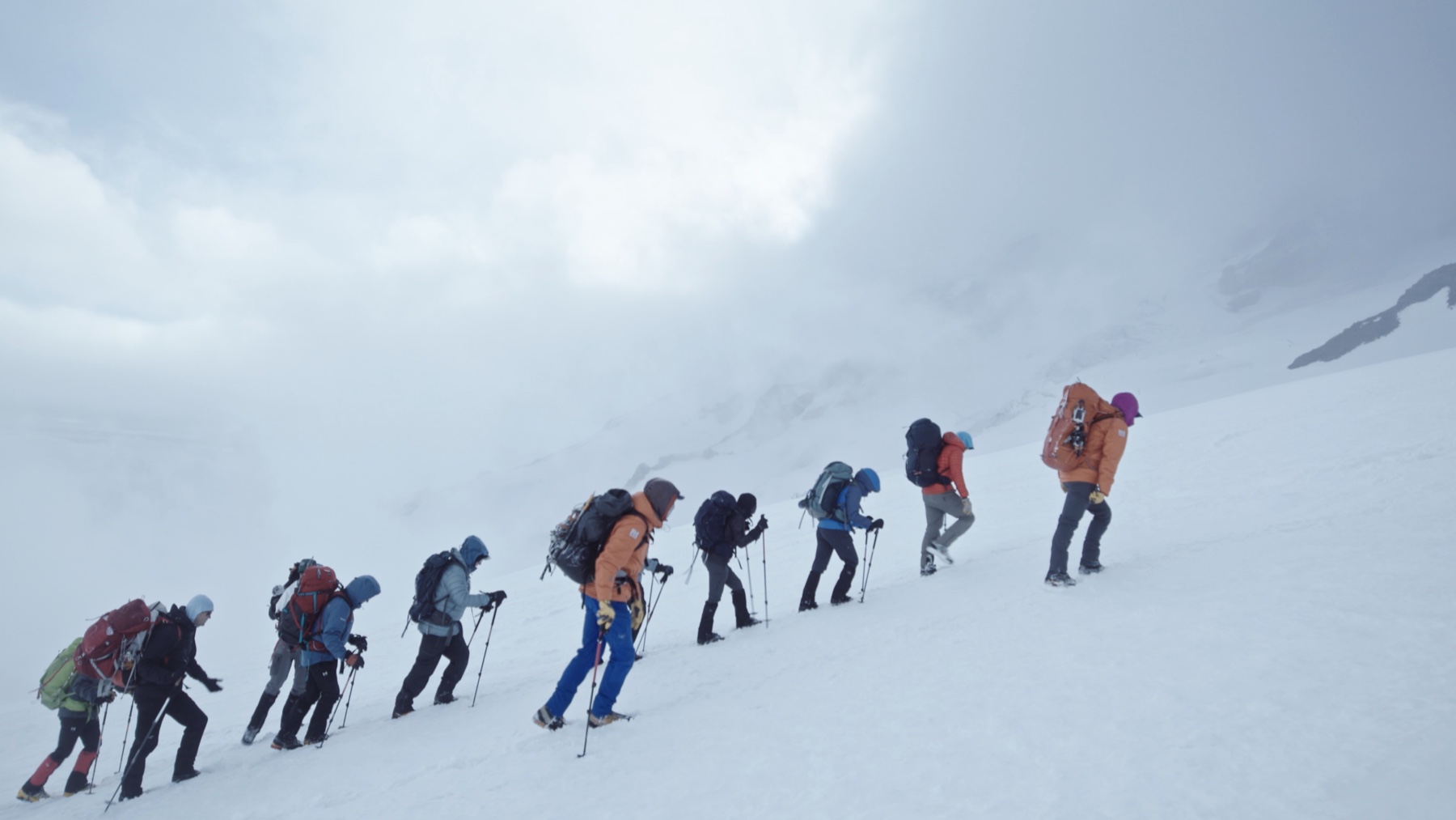 The Inspiration4 expedition team ascending a snow-covered mountain