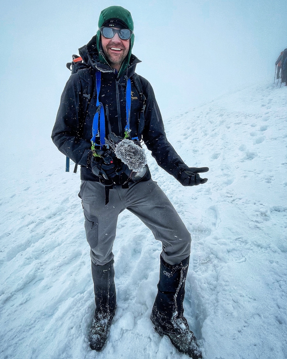 A production crew member recording sound in winter conditions