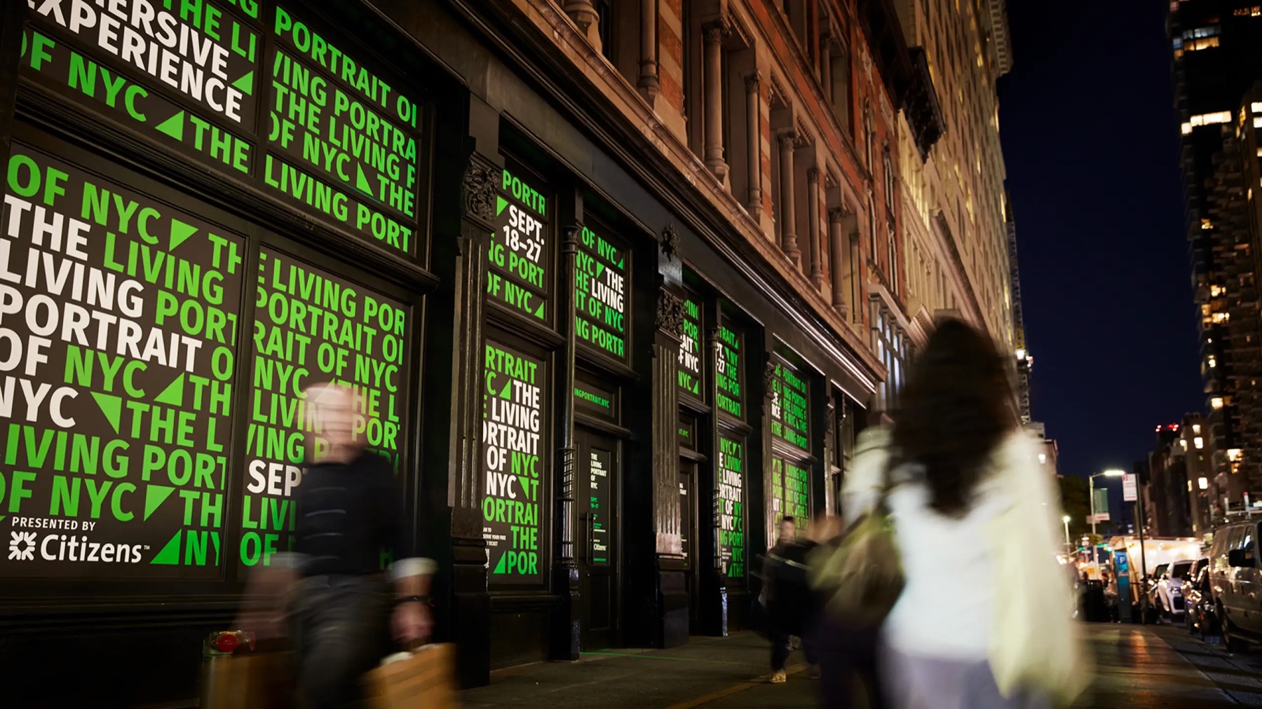 The Living Portrait of NYC venue illuminated at night