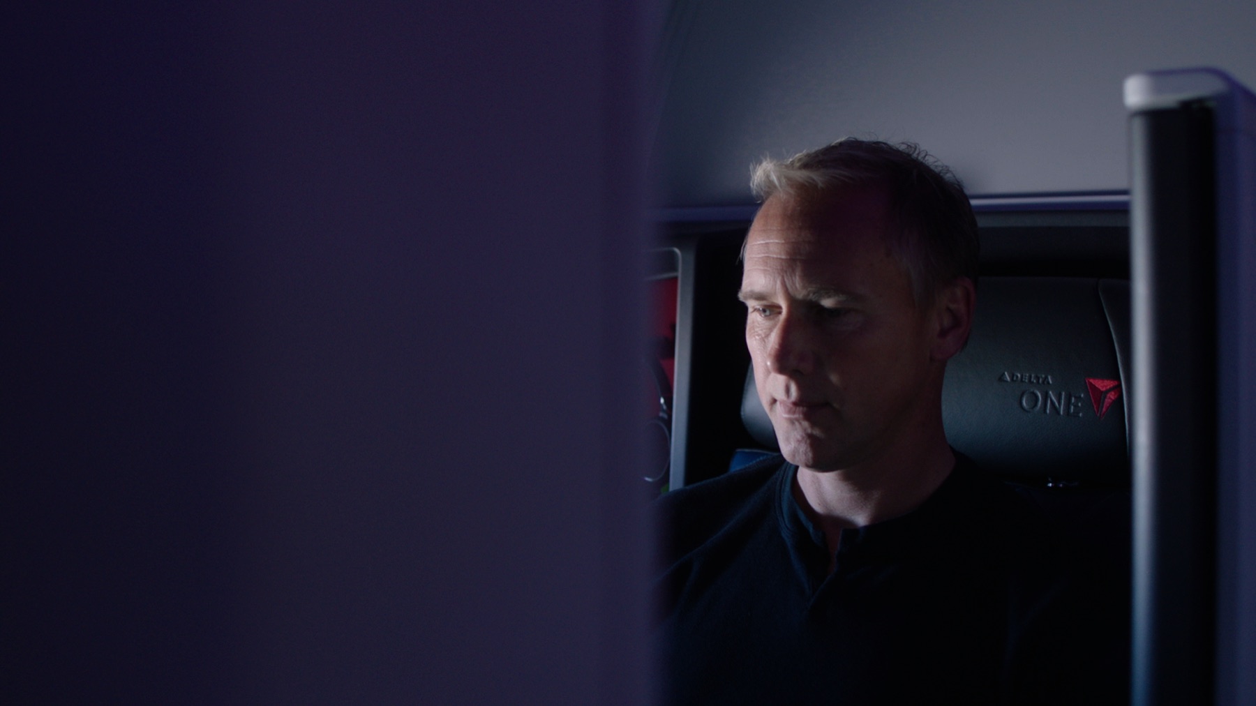 A football executive traveling in a Delta One cabin