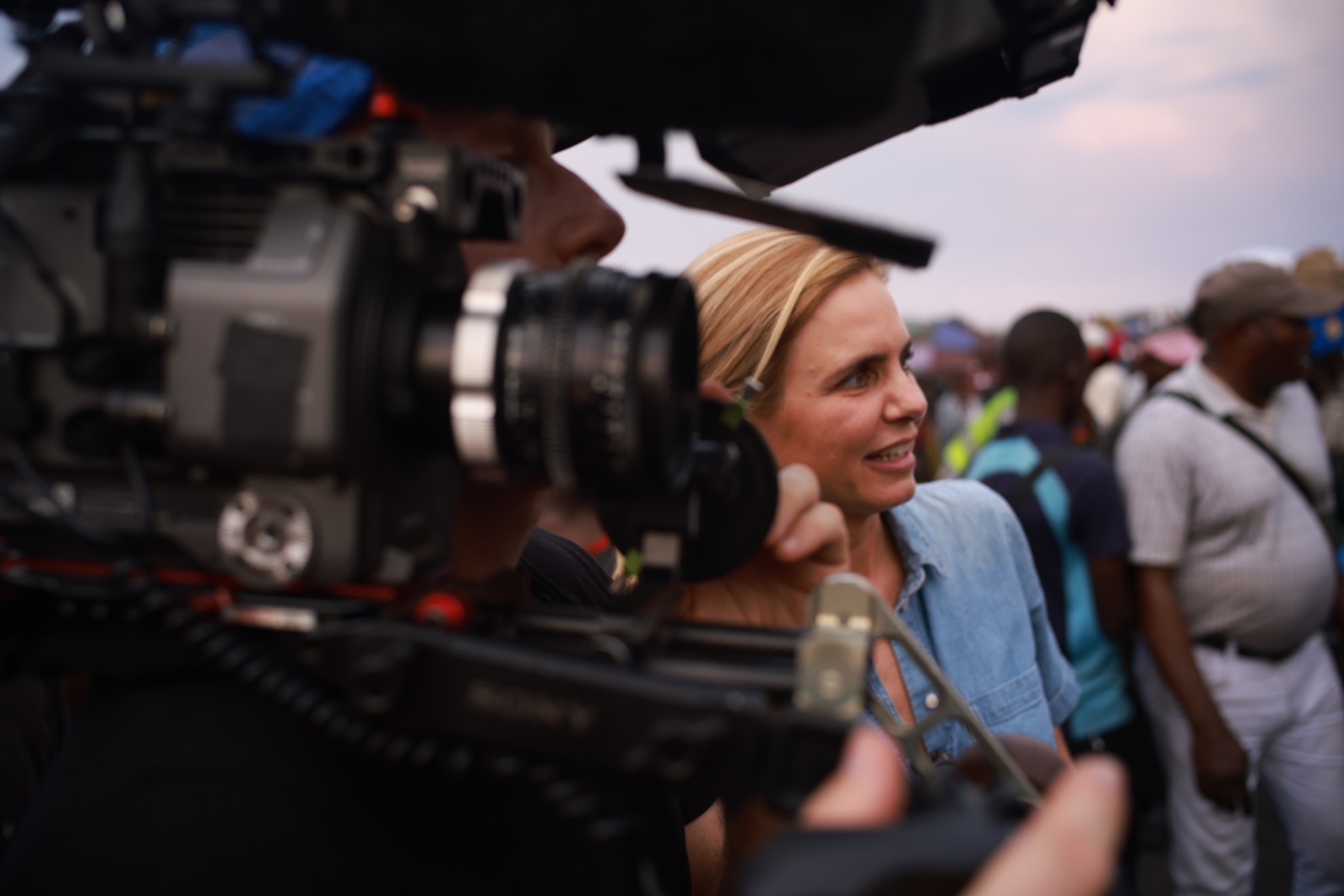A camera filming Mariana van Zeller during a field interview