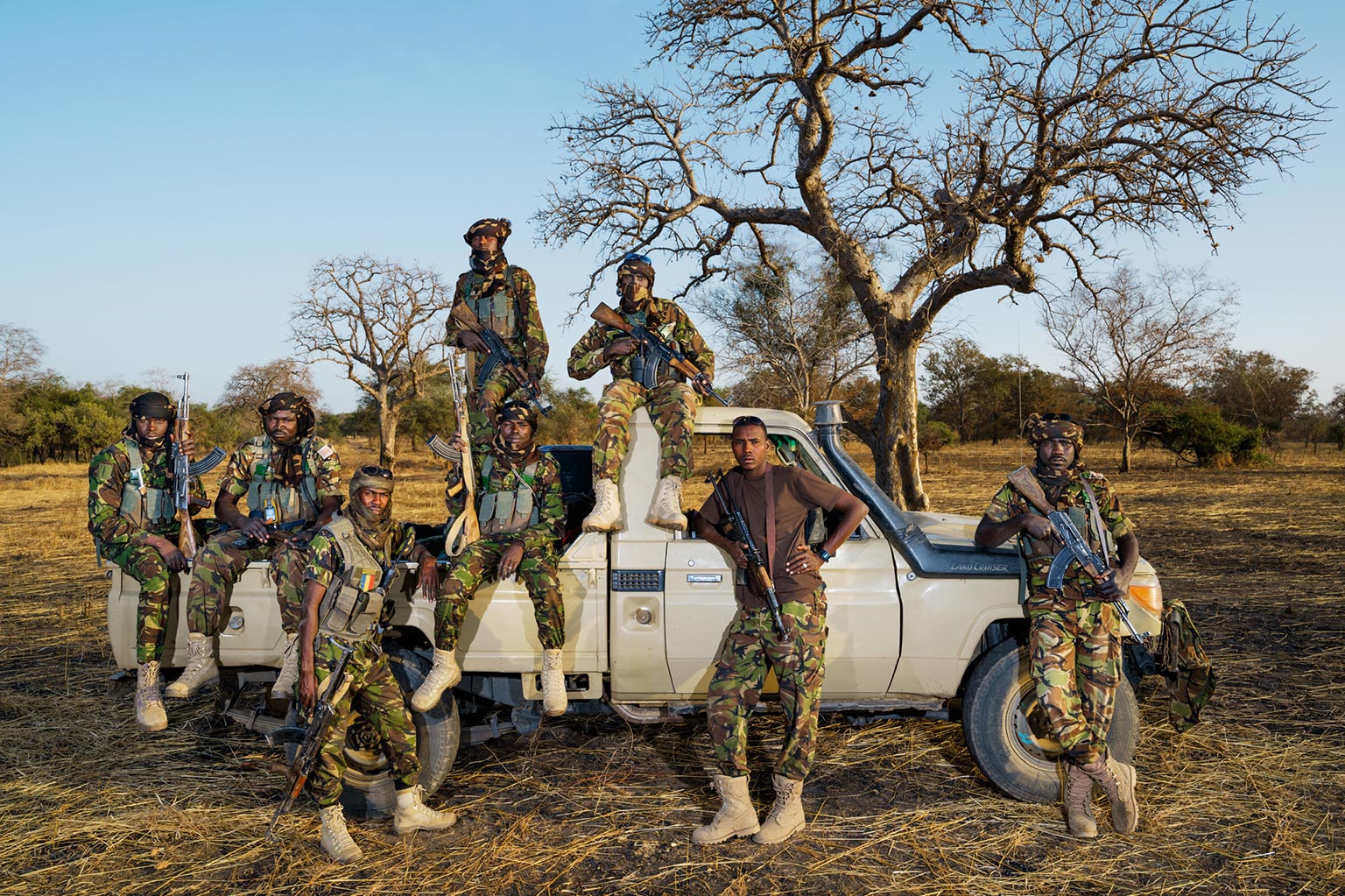 An anti-poaching unit gathered around a field vehicle